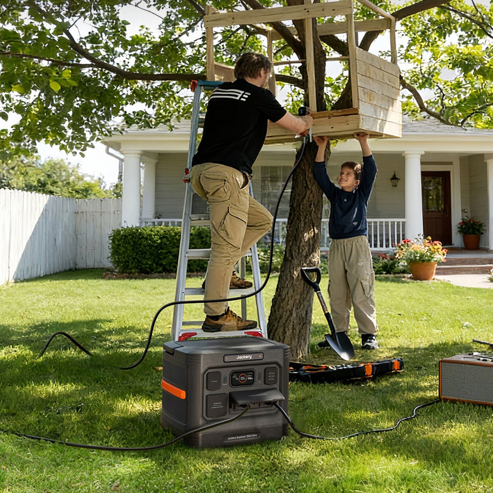 Two people working on a tree with a Jackery Explorer 1500 Ultra Portable Power Station in the foreground