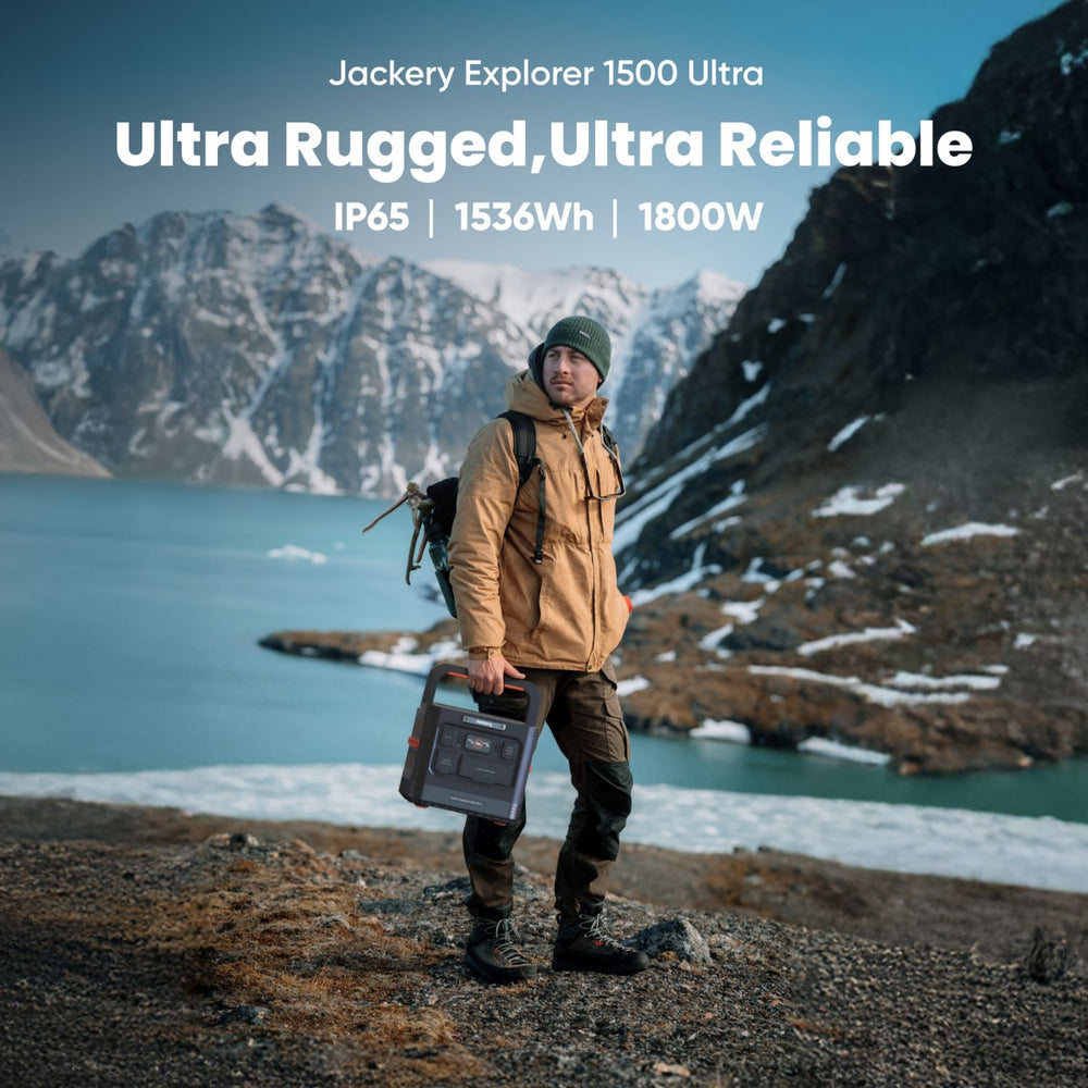 Person holding a Jackery Explorer 1500 Ultra power station in a mountainous landscape
