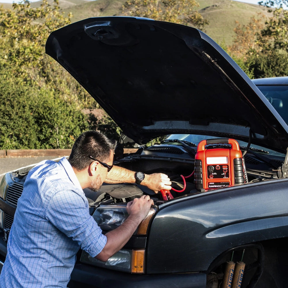 A Man Jumpstarting A Car With Wagan Tech JumpBoost V8 Air