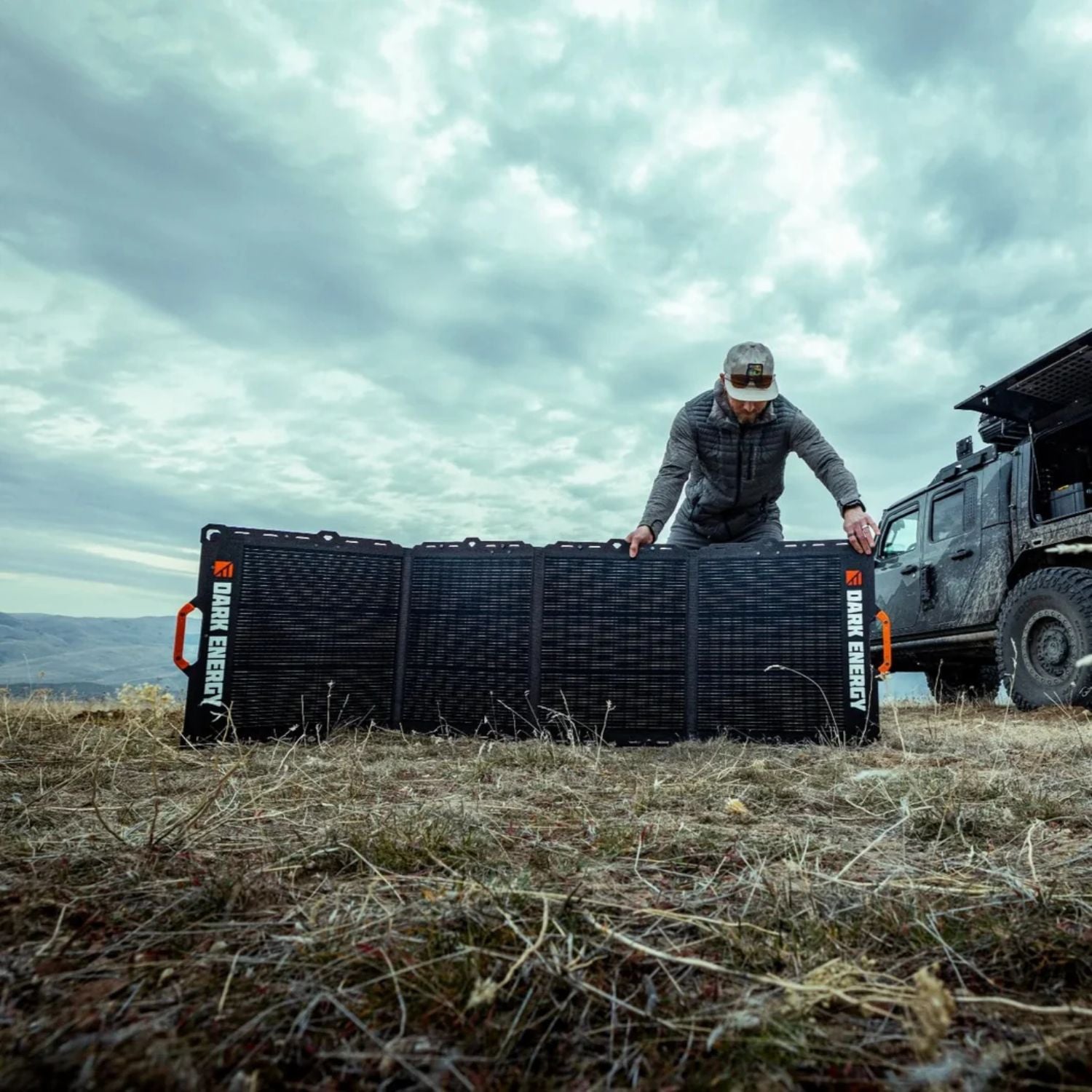 A man holding a Dark Energy Spectre 200W Solar Panel 