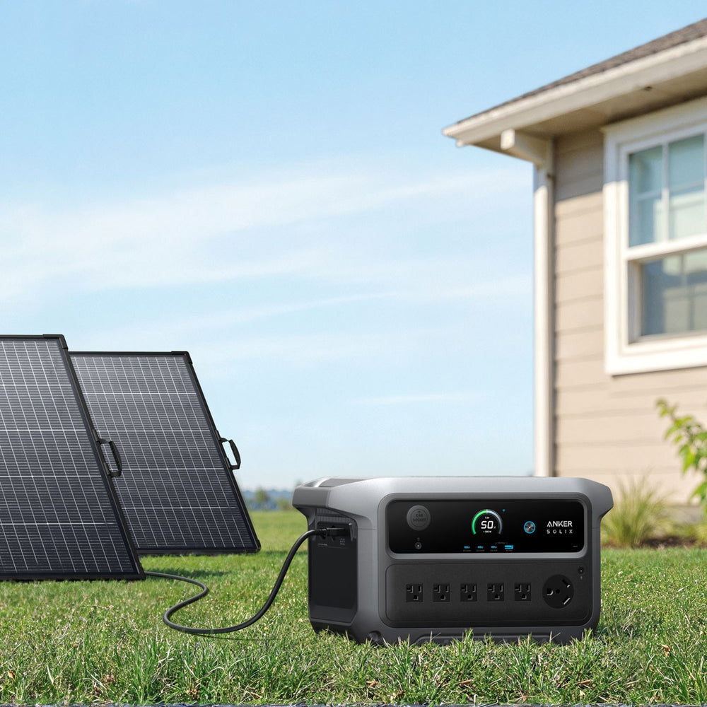 Anker SOLIX C2000 Gen 2 Portable Power Stationwith solar panels in front of a house