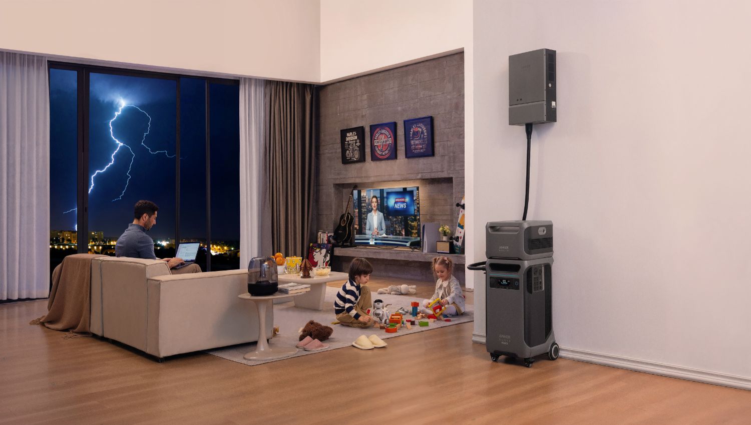 Anker SOLIX F3800 Plus Power Station connected to an expansion battery in a living room, with two kids and a man using a laptop