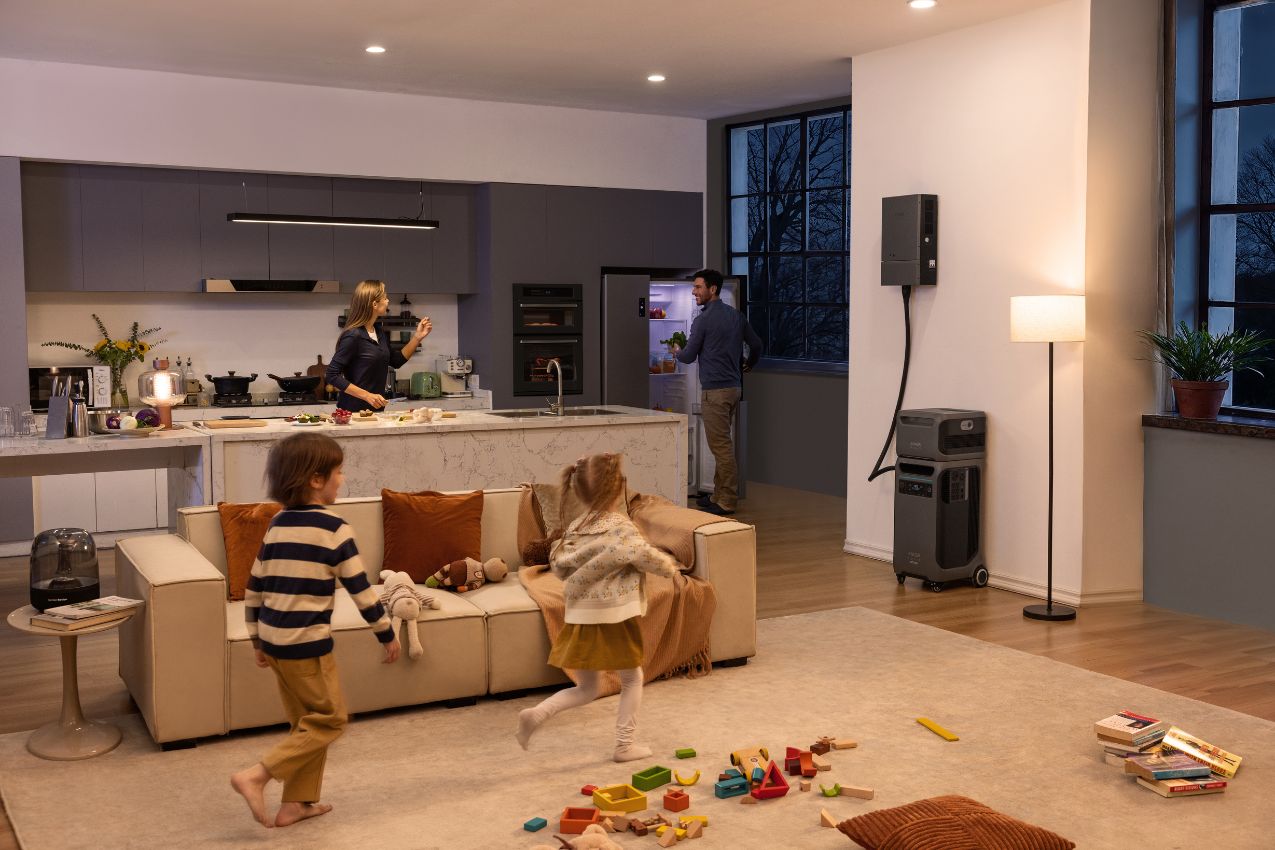 Anker SOLIX F3800 Plus Power Station in the kitchen with two kids playing, one person opening the fridge, and a woman cooking