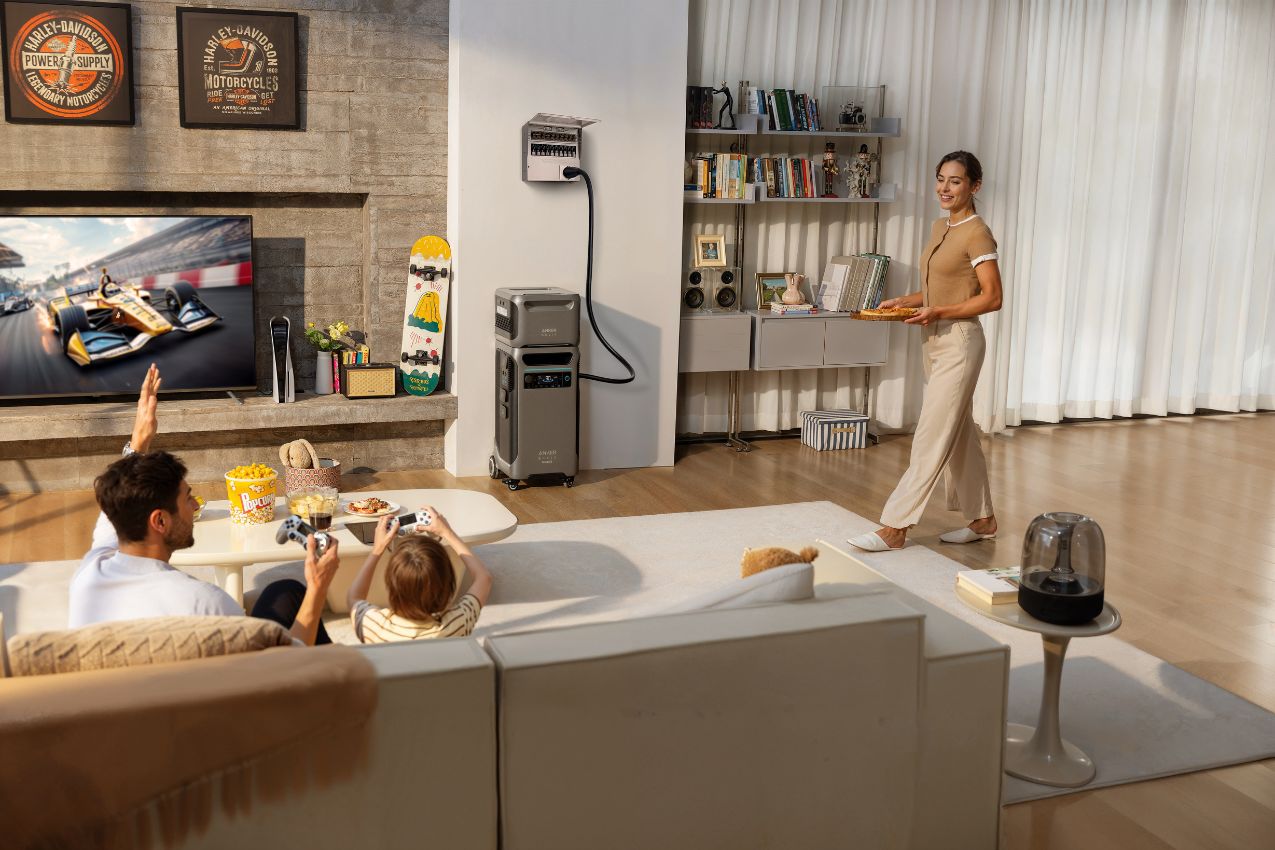 Anker SOLIX F3800 Plus Power Station in the living room with three people watching TV
