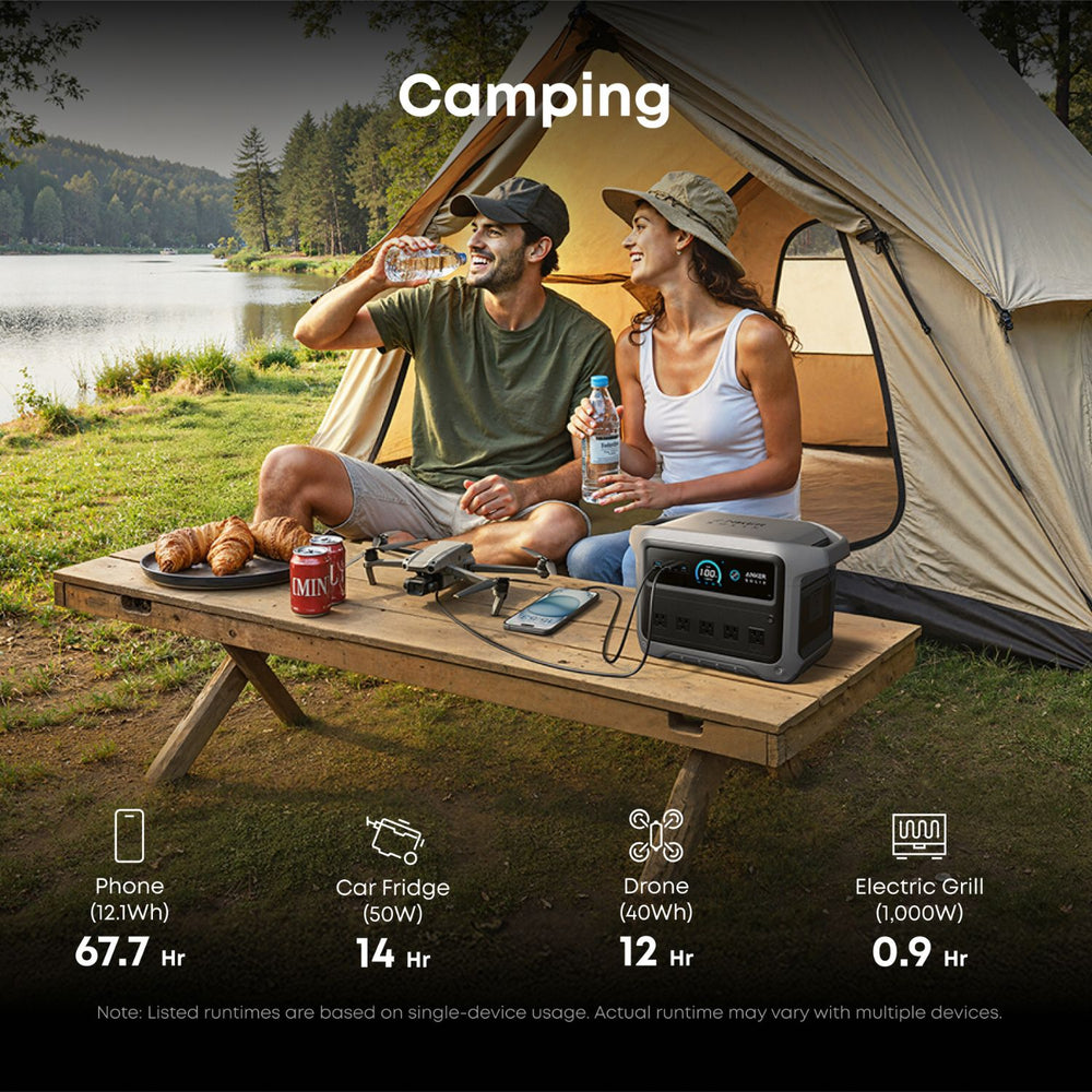 Couple camping by a lake with a Anker SOLIX C1000 Gen 2 Portable Power Station on a picnic table.