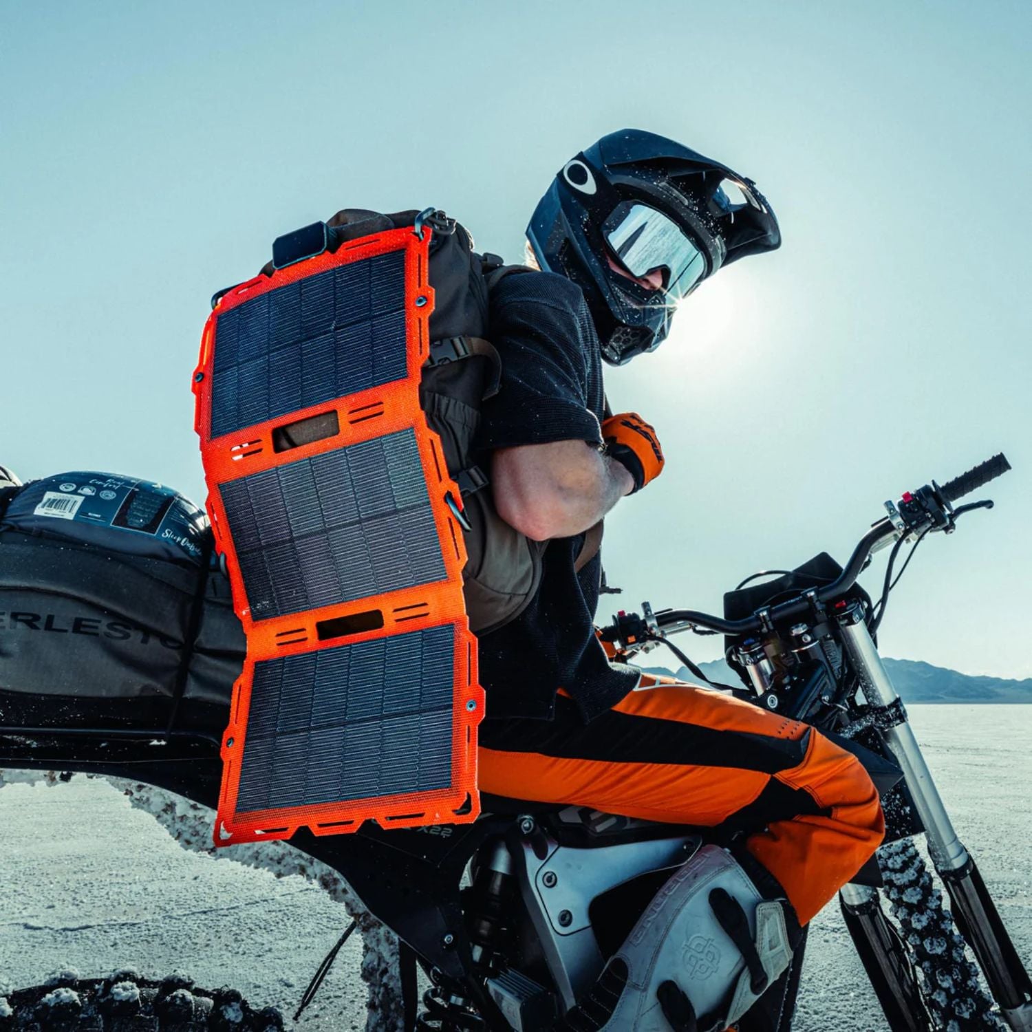 Dark Energy Spectre 18W Solar Panel - Orange at the back of a man riding his motorcycle 