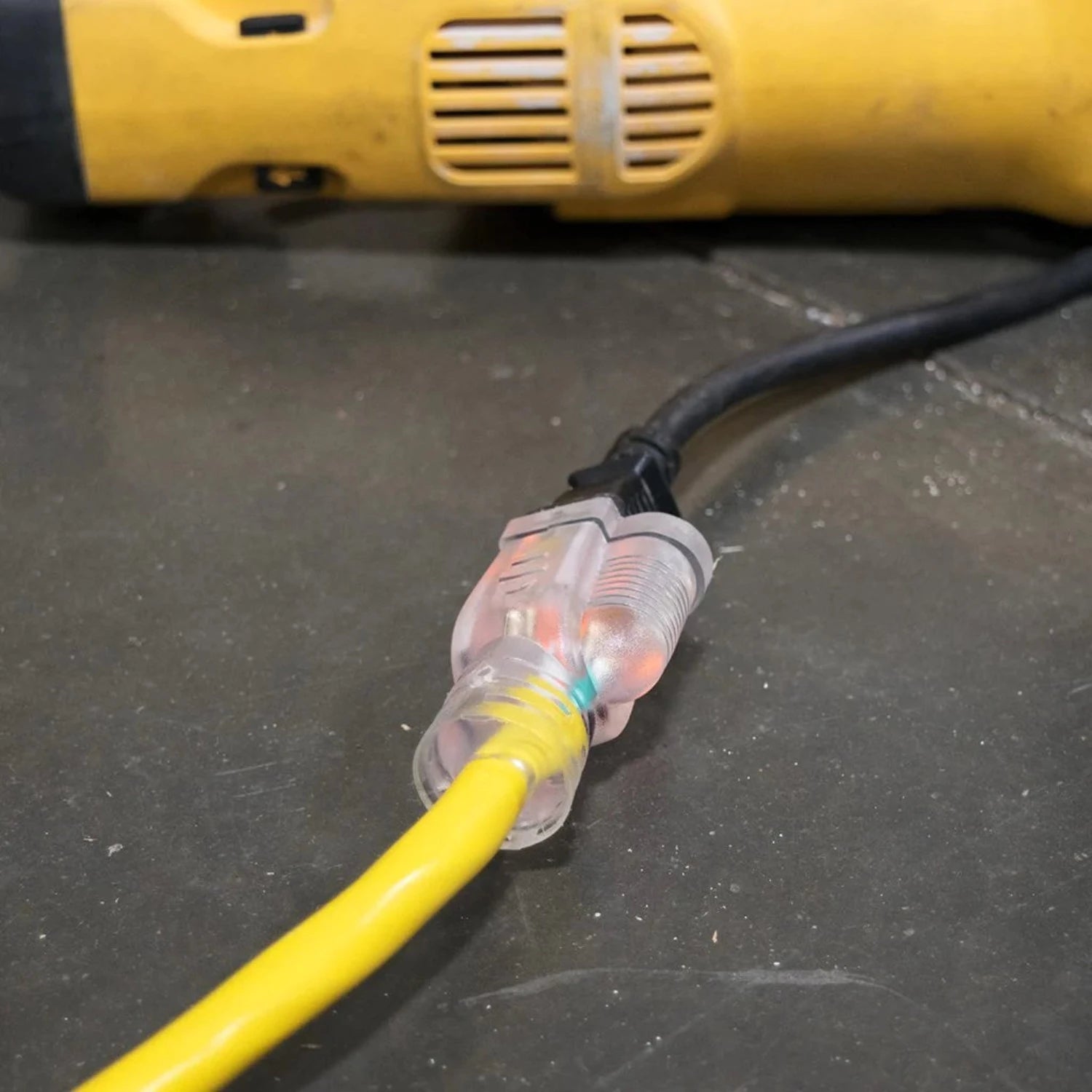 DuroMax 50-Foot 10 Gauge Single Tap Extension Power Cord With Lighted End Plugged Into A Device