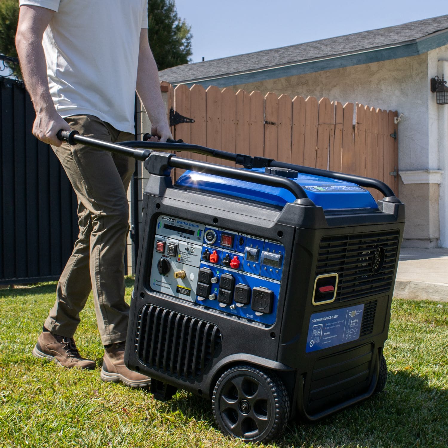 DuroMax XP11000iH Portable Dual Fuel Inverter Generator w/ CO Alert  man holding it 