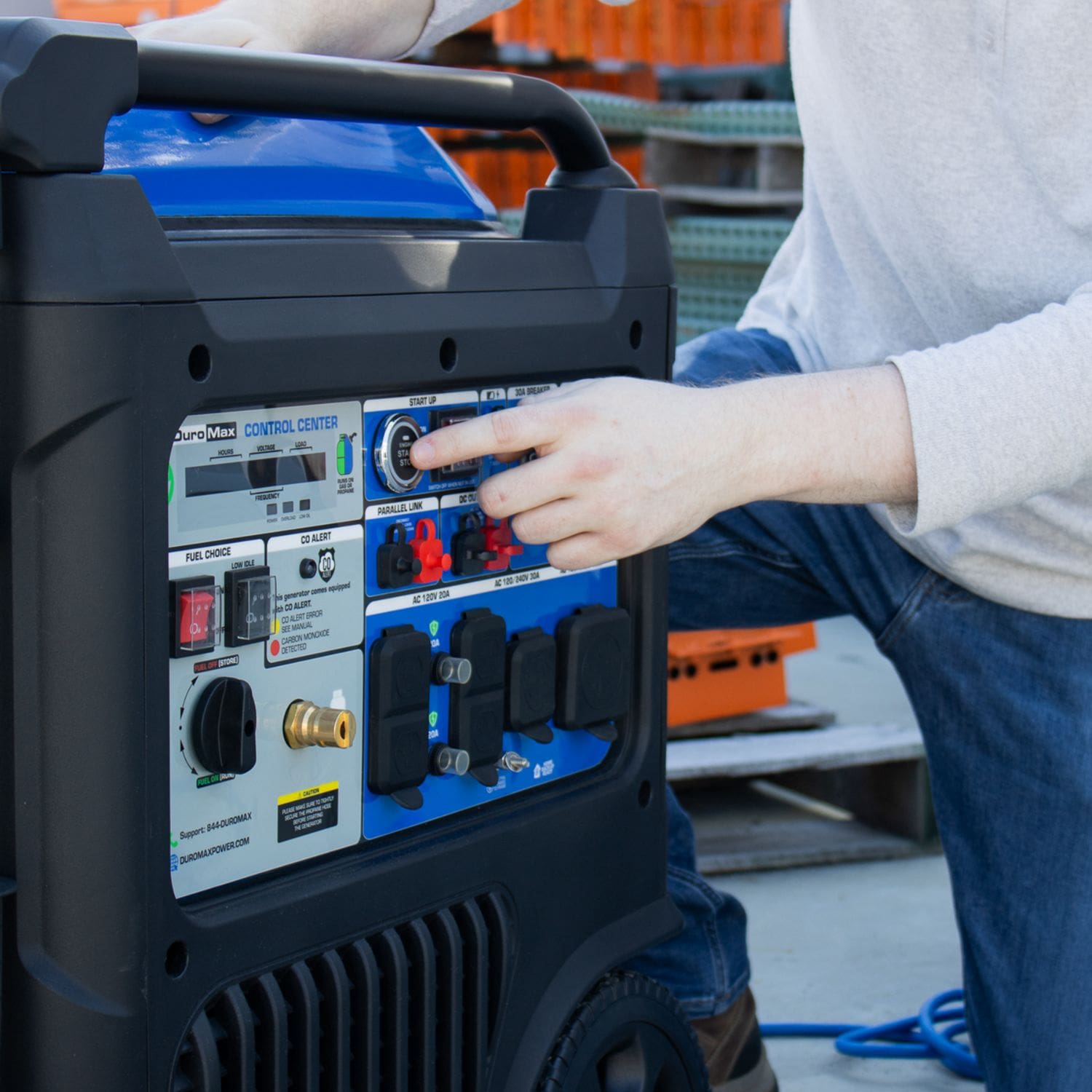 DuroMax XP11000iH Portable Dual Fuel Inverter Generator w/ CO Alert man turning it on