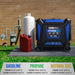 DuroMax XP16000HT tri-fuel generator with fuel canister and propane tank against a brick wall.