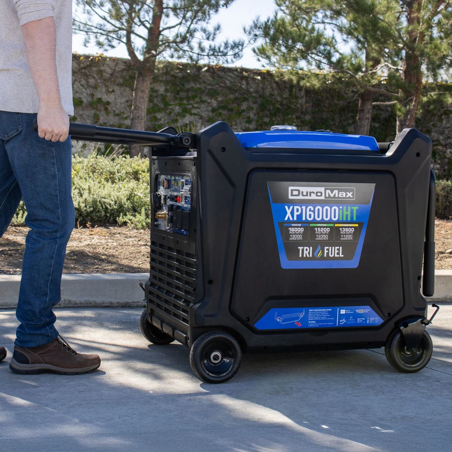 DuroMax XP16000iHT Tri-Fuel Generator  being pushed by a person outdoors