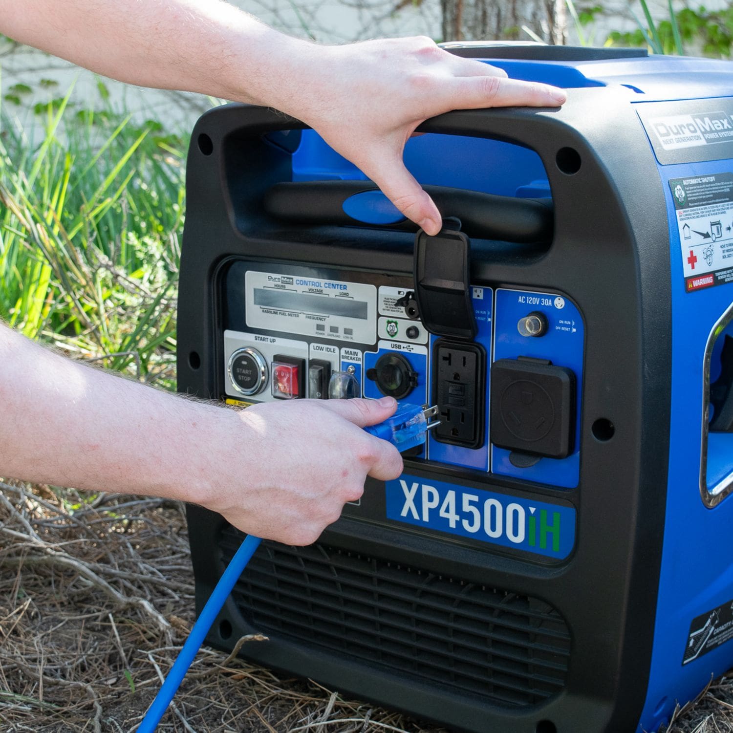 DuroMax XPX10100A Heavy Duty SJEOOW 100-Foot 10 Gauge Blue Single Tap Extension Power Cord Being Plugged Into A Generator