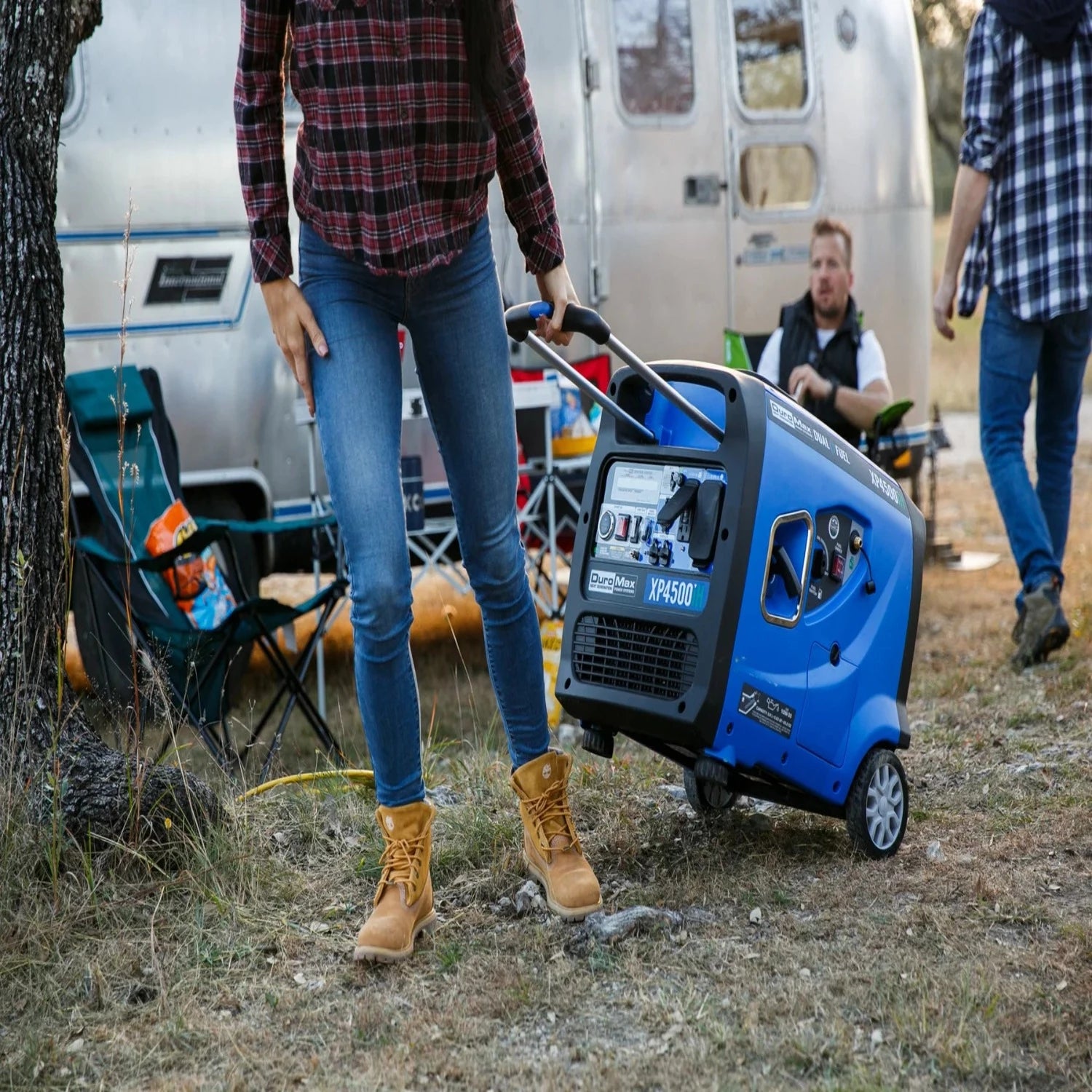 DuroMax XP4500iH Generator Being Carried With The Handle Near An RV