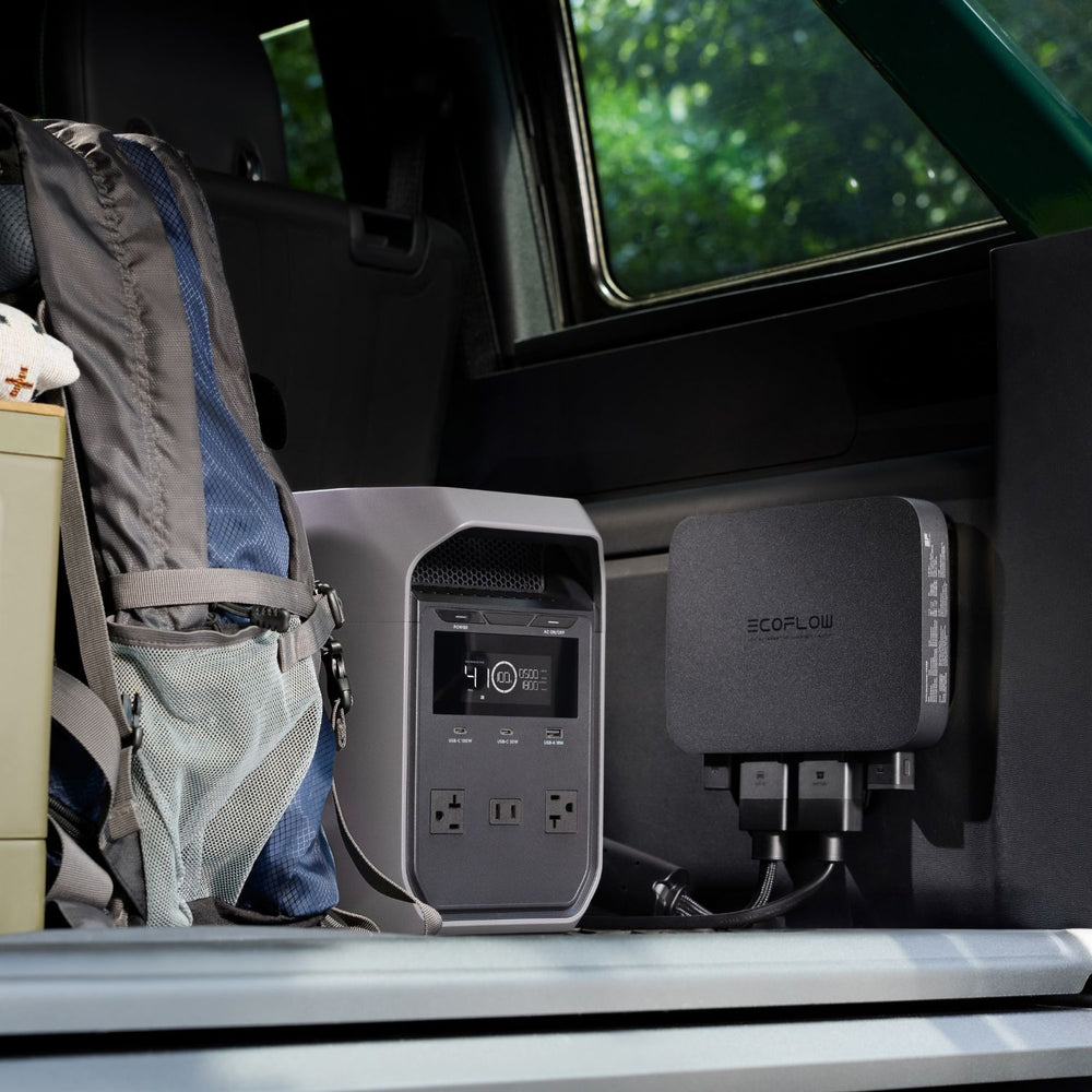EcoFlow DELTA 3 Classic Portable Power Station and charger in a vehicle's open door with greenery outside