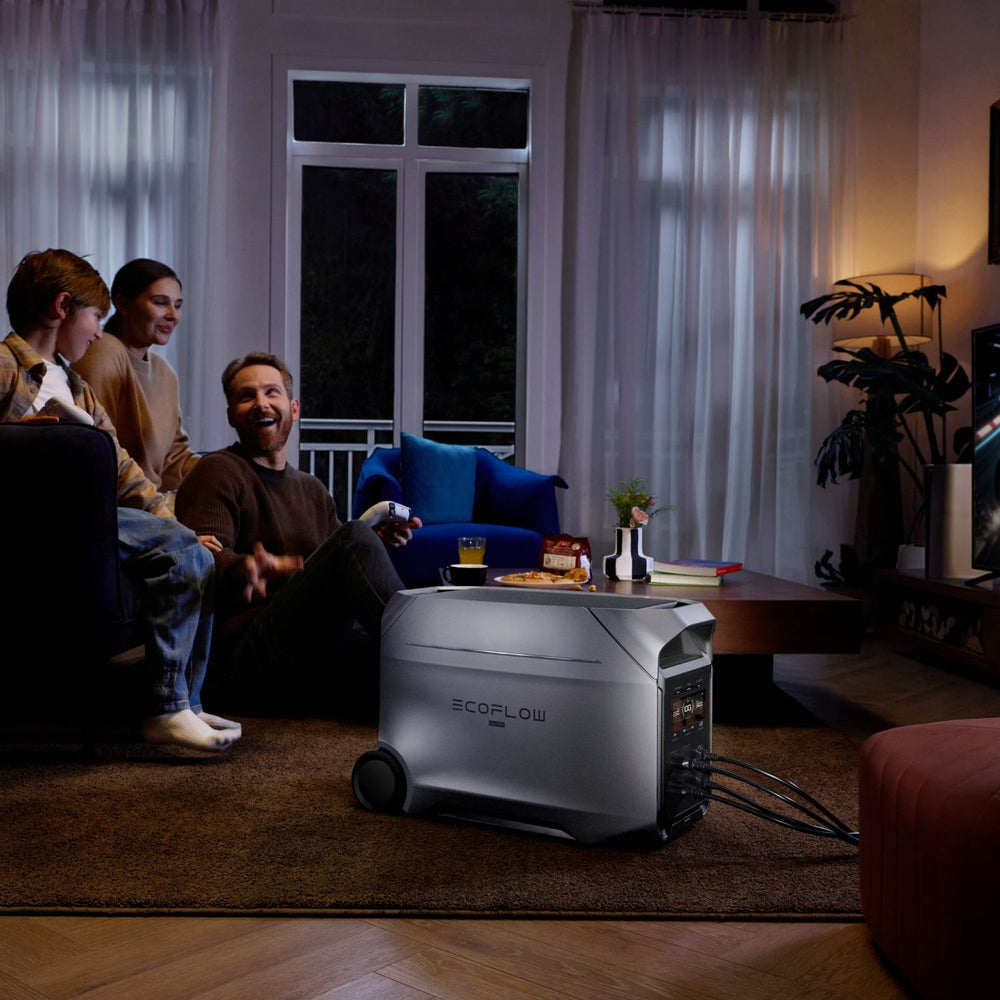 Family sitting in a living room with an EcoFlow DELTA 3 Ultra Plus Portable Power Station on a coffee table.