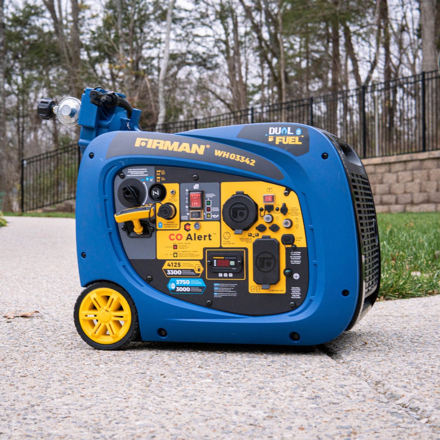 Firman WH03342 Dual Fuel Inverter Generator 4125W placed outdoors, showing labeled control panel and wheels.