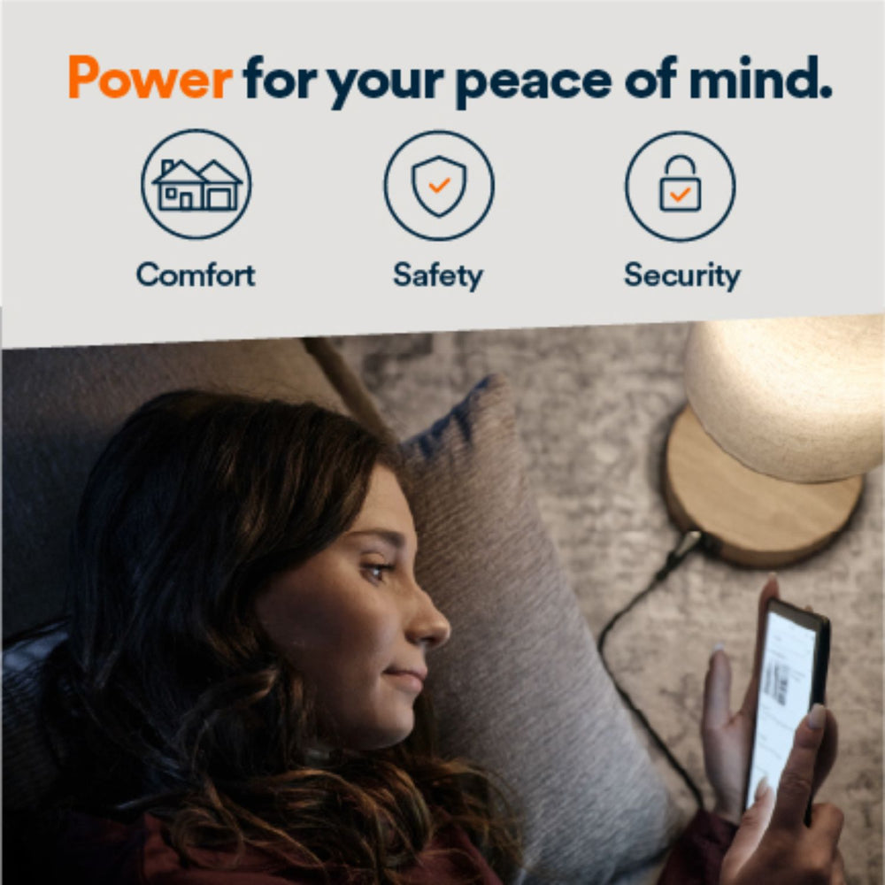 Generac Next-Gen 28kW Home Standby Generator monitored using a phone by a woman