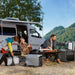 Group of people camping outdoors with a van, picnic setup, and EcoFlow DELTA 3 Ultra Plus Portable Power Station 