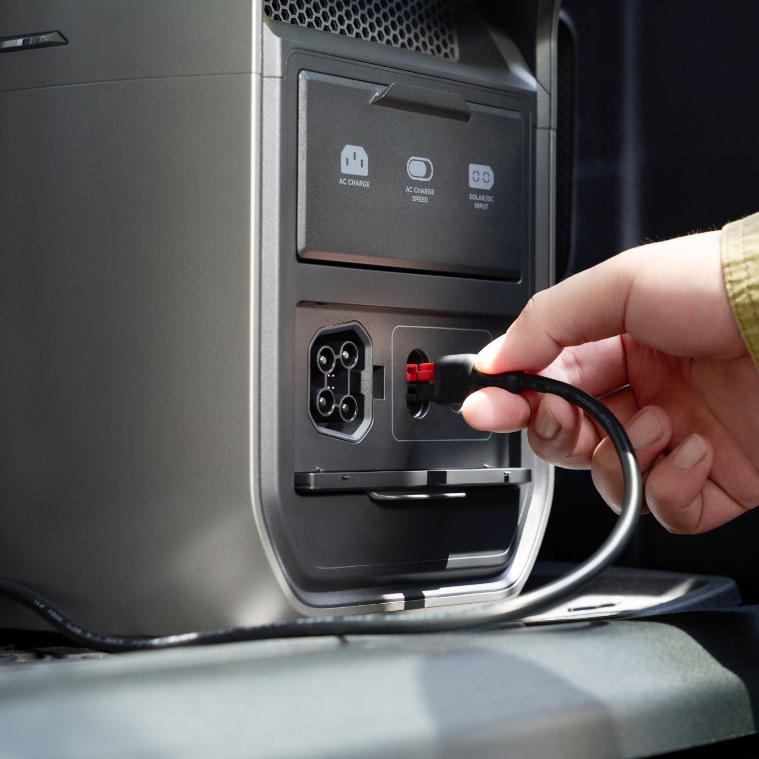 Hand plugging a cable into a EcoFlow DELTA 3 Max Plus Portable Power Station