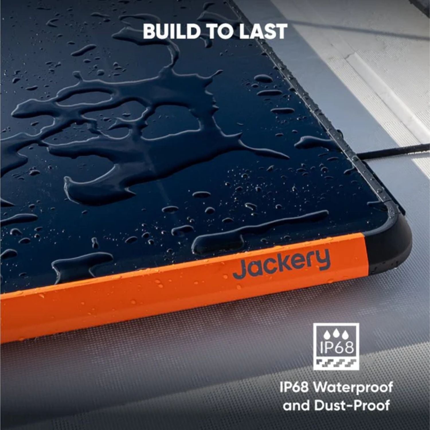 Jackery 100W Prime Solar Panel waterproof case with raindrops on a gray surface, featuring the brand name and IP68 certification.