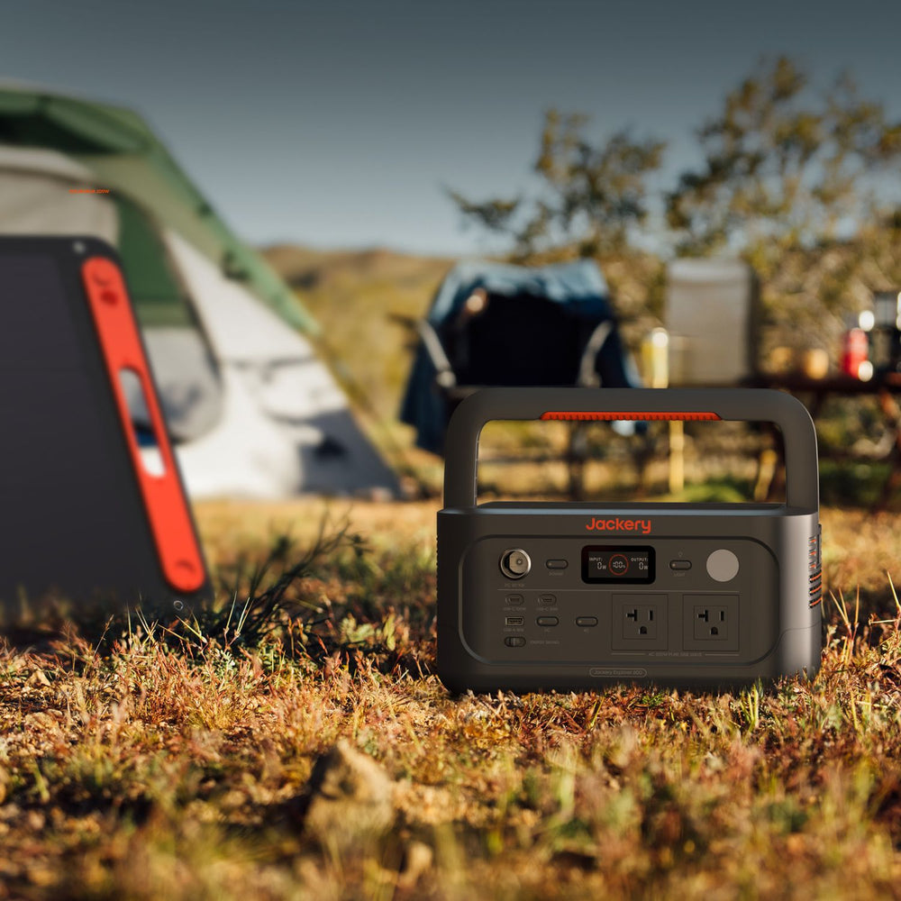 Jackery Explorer 600 v2 in a camping setting with tents