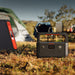 Jackery Explorer 600 v2 in a camping setting with tents