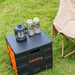 Jackery portable power station with a Jackery Camping Lantern and beer cans on grass