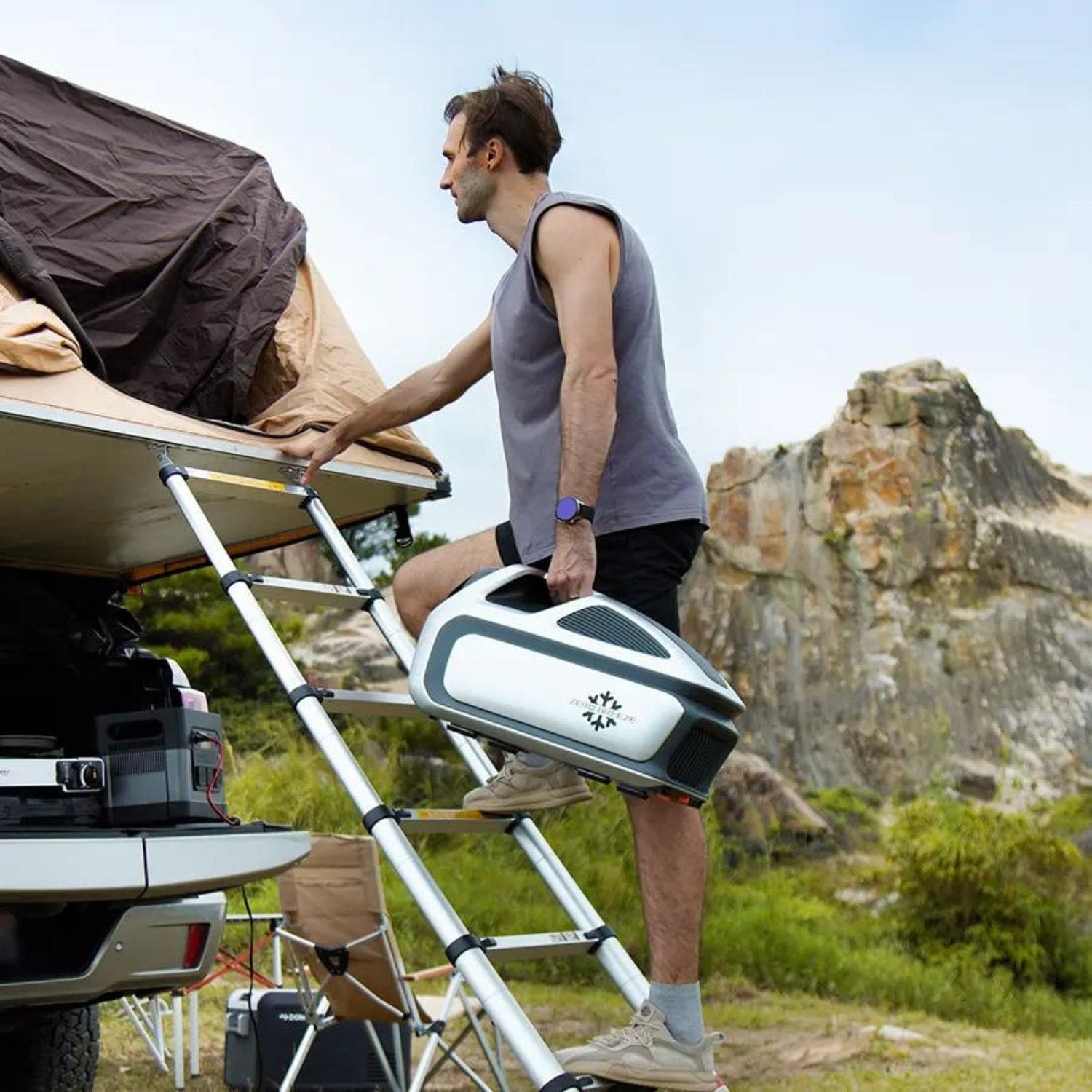 Man Climbing Into A Rooftop Tent With A ZERO BREEZE Mark 3