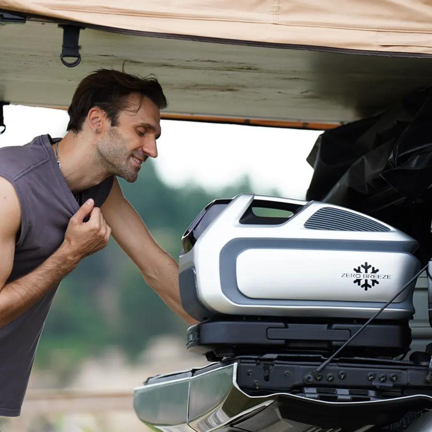 Man Enjoying The Cool Air From A ZERO BREEZE Mark 3 While It Sits On The Bed Of A Truck