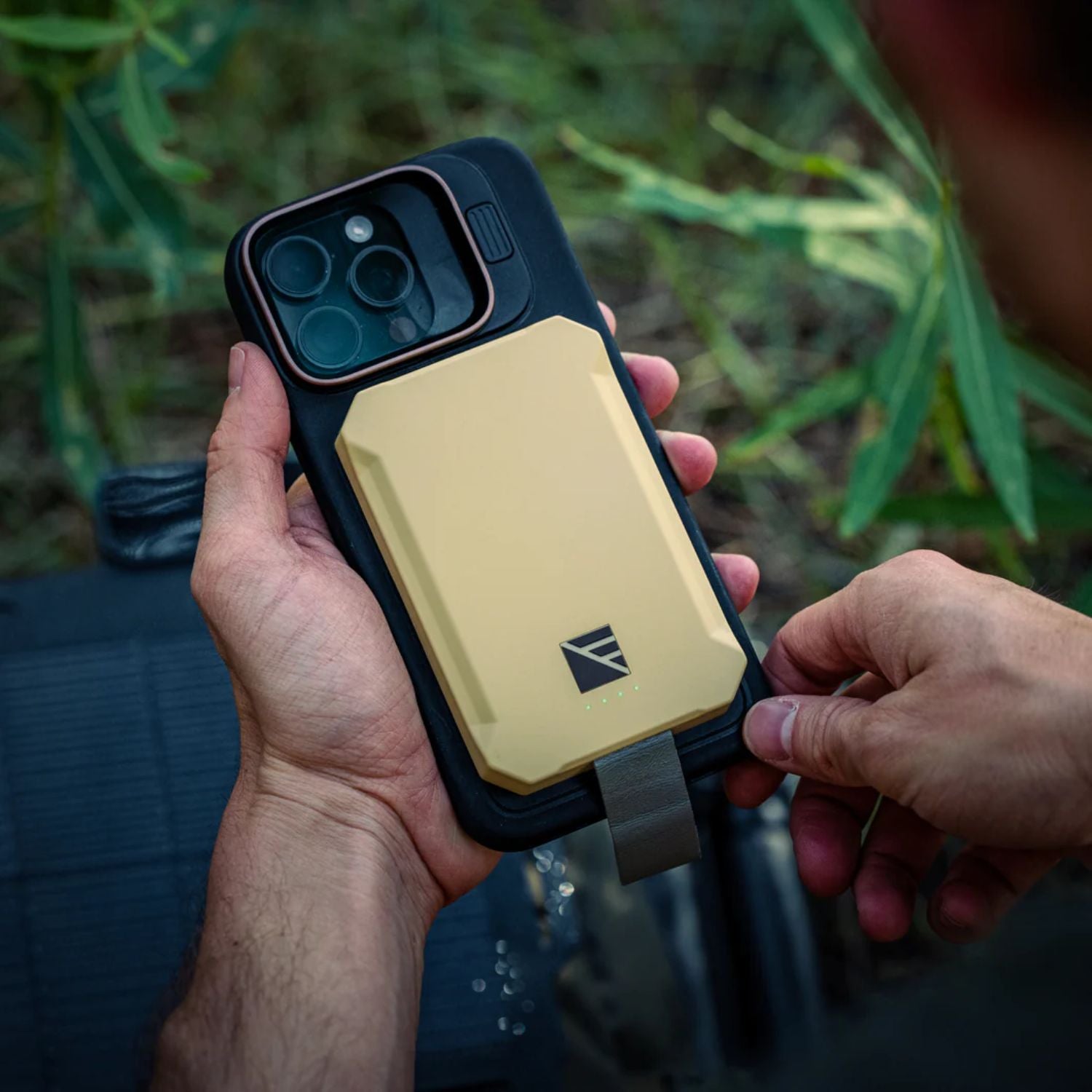 Man Holding the Dark Energy Poseidon Nano Power Bank - Desert