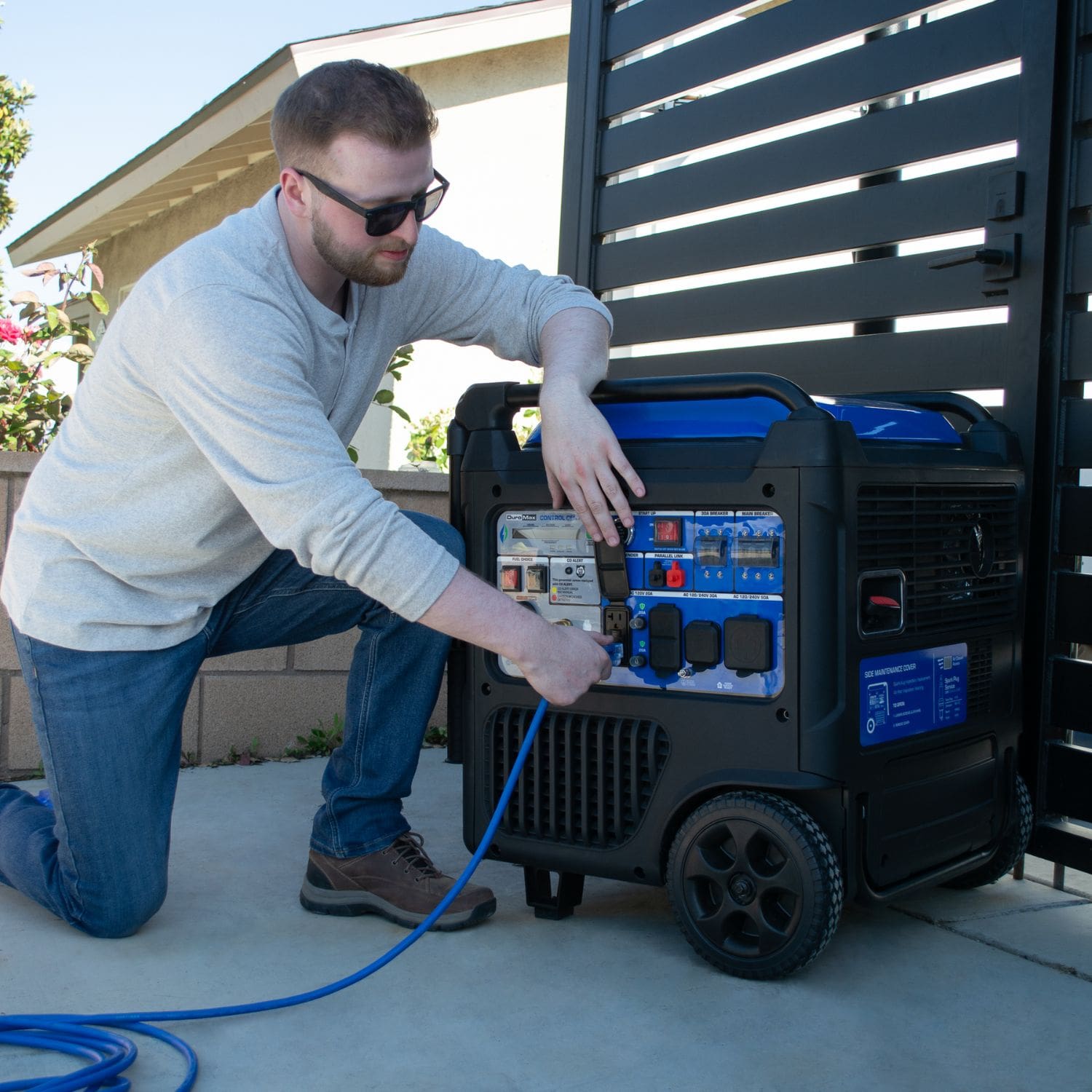 Man Plugging In A Power Cord To The DuroMax XP9500iH
