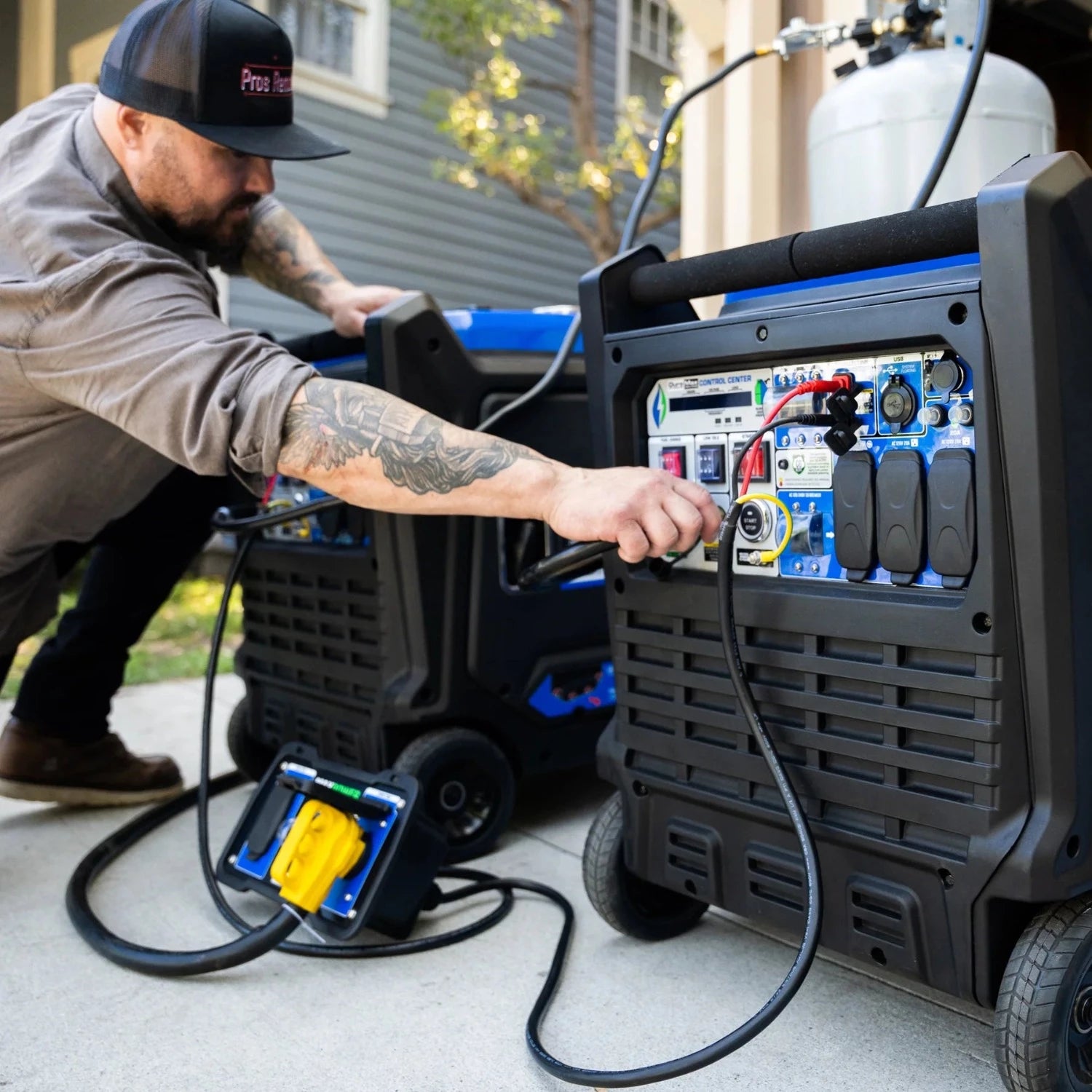 Man Plugging Two XP9000iH Generators Into The DuroMax Inverter Parallel Kit 