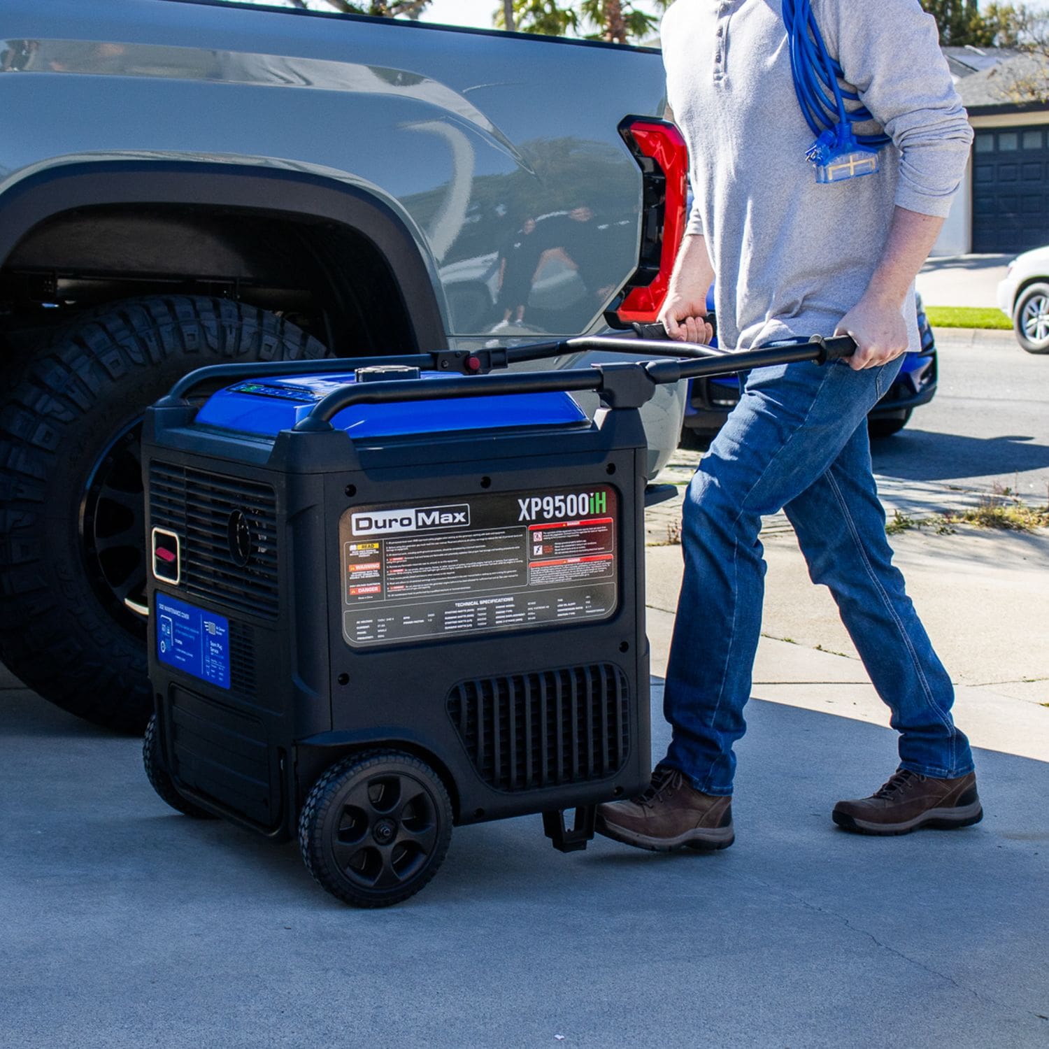 Man Pushing A DuroMax XP9500iH Dual Fuel Generator