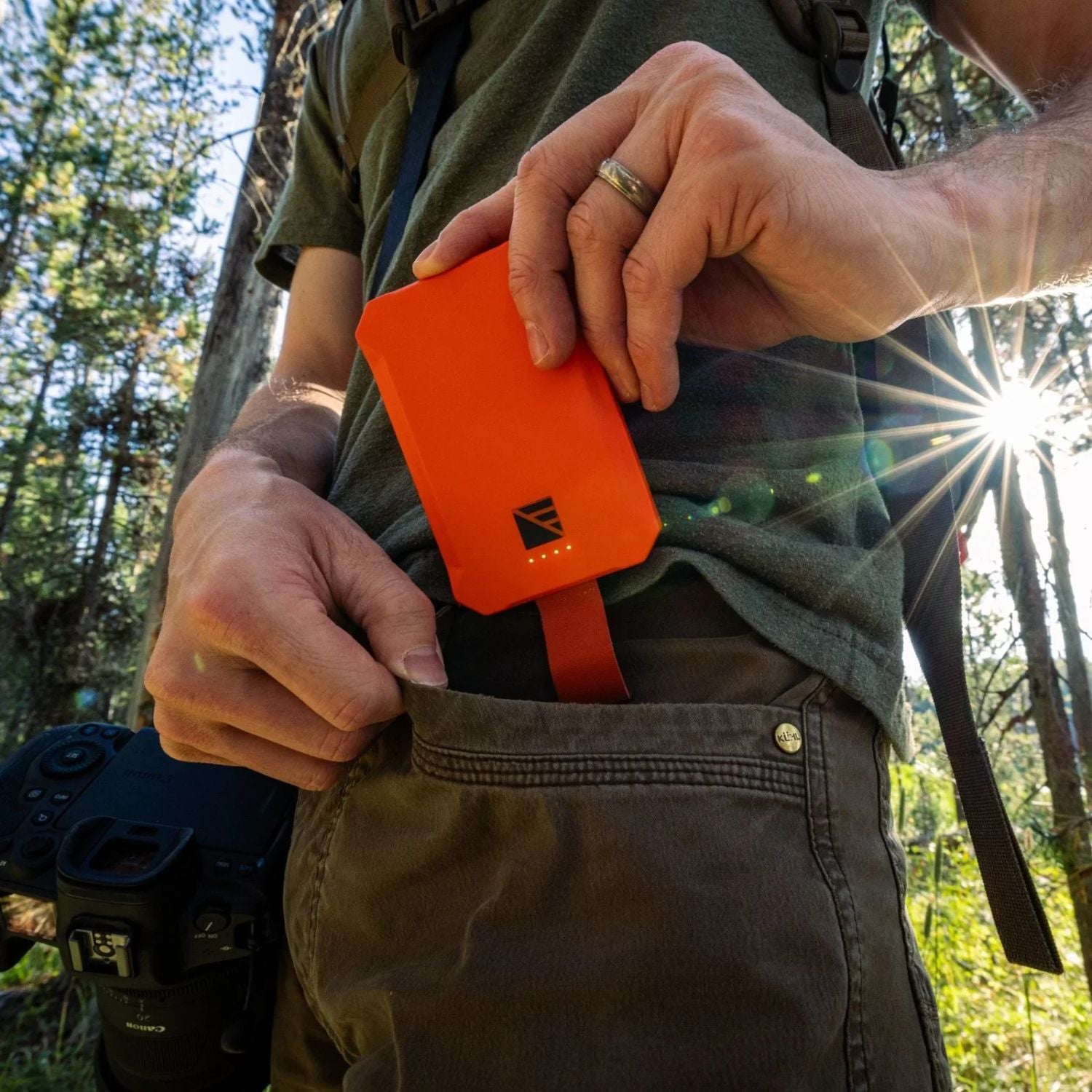 Man Putting Dark Energy Poseidon Nano Power Bank - Orange into his pocket