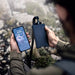 Man holding Dark Energy Poseidon Pro Power Bank - Black connected to a phone