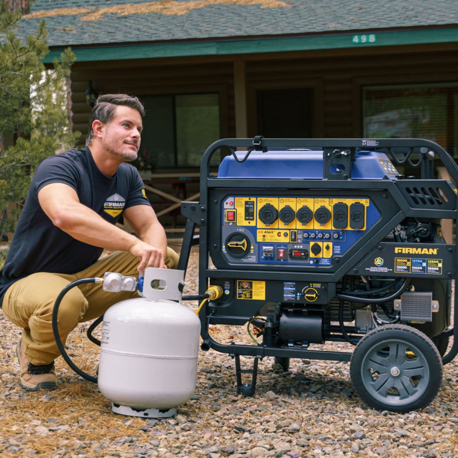 Man holding a propane tank, preparing to connect it to the Firman T12071 Tri-Fuel Portable Generator