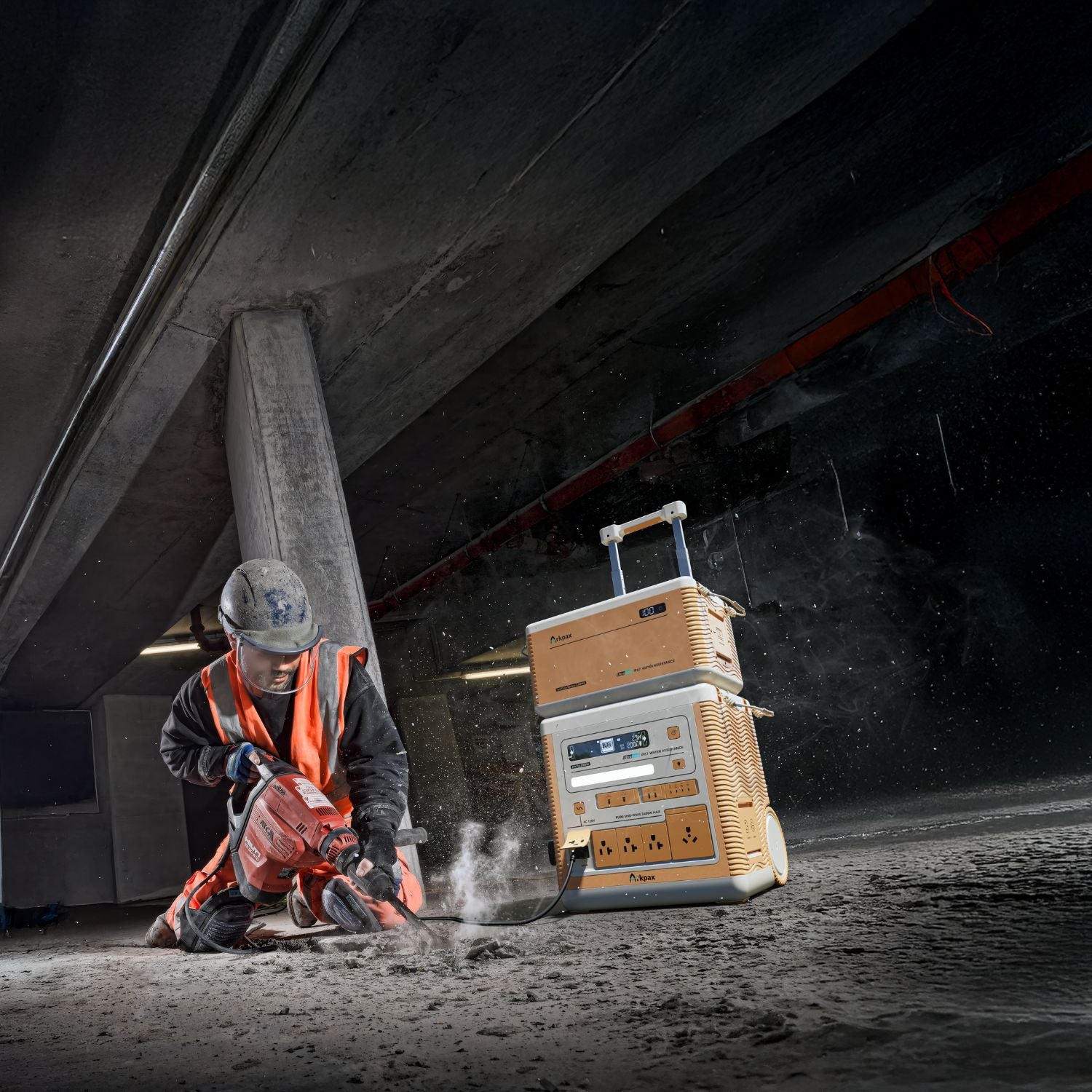 Man using Arkpax Ark Pro portable power station to drill into cement floor