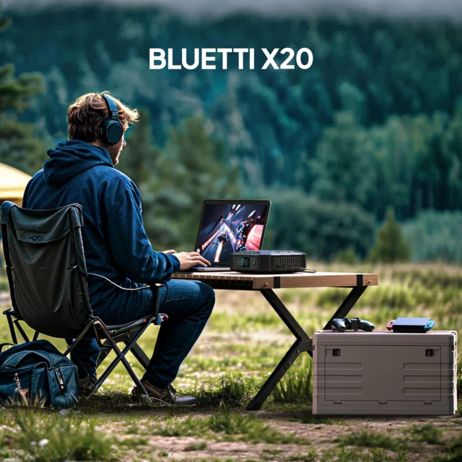 Man using BLUETTI X20 Power Bank to power his laptop outdoors