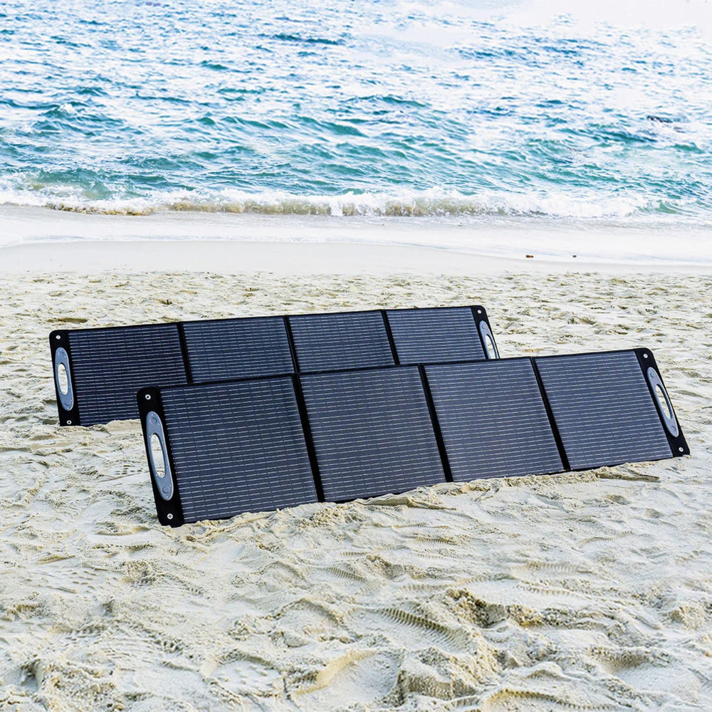 OUKITEL 200W Portable Solar Panel on a sandy beach with ocean in the background