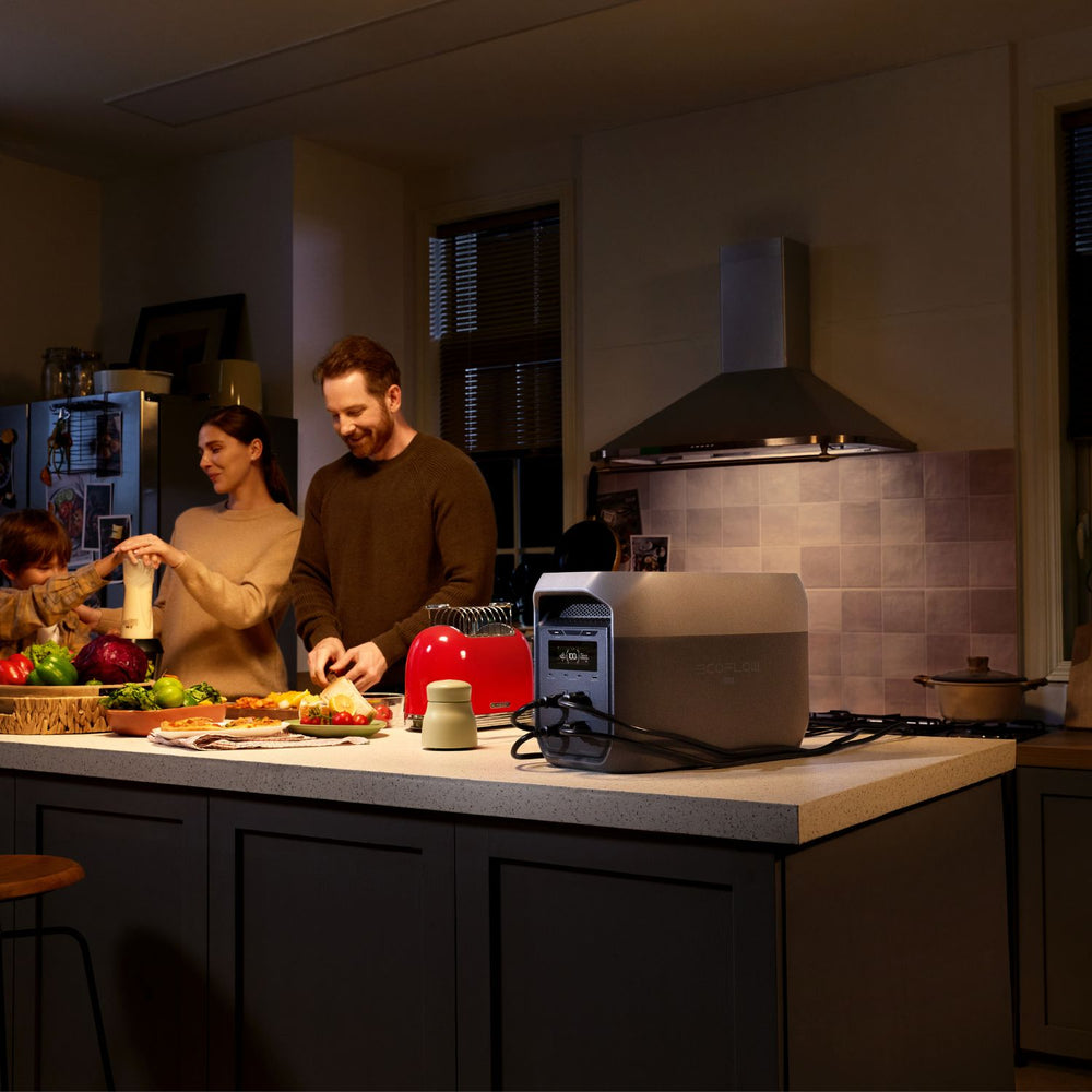 People preparing food in a kitchen with a toaster on the counter connected to EcoFlow DELTA 3 Max Portable Power Station Black silver