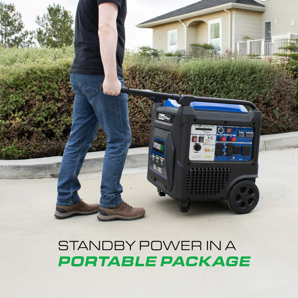 Person pushing a DuroMax XP11000iHT Portable Inverter Generator  with text 'Standby power in a portable package' on a driveway.