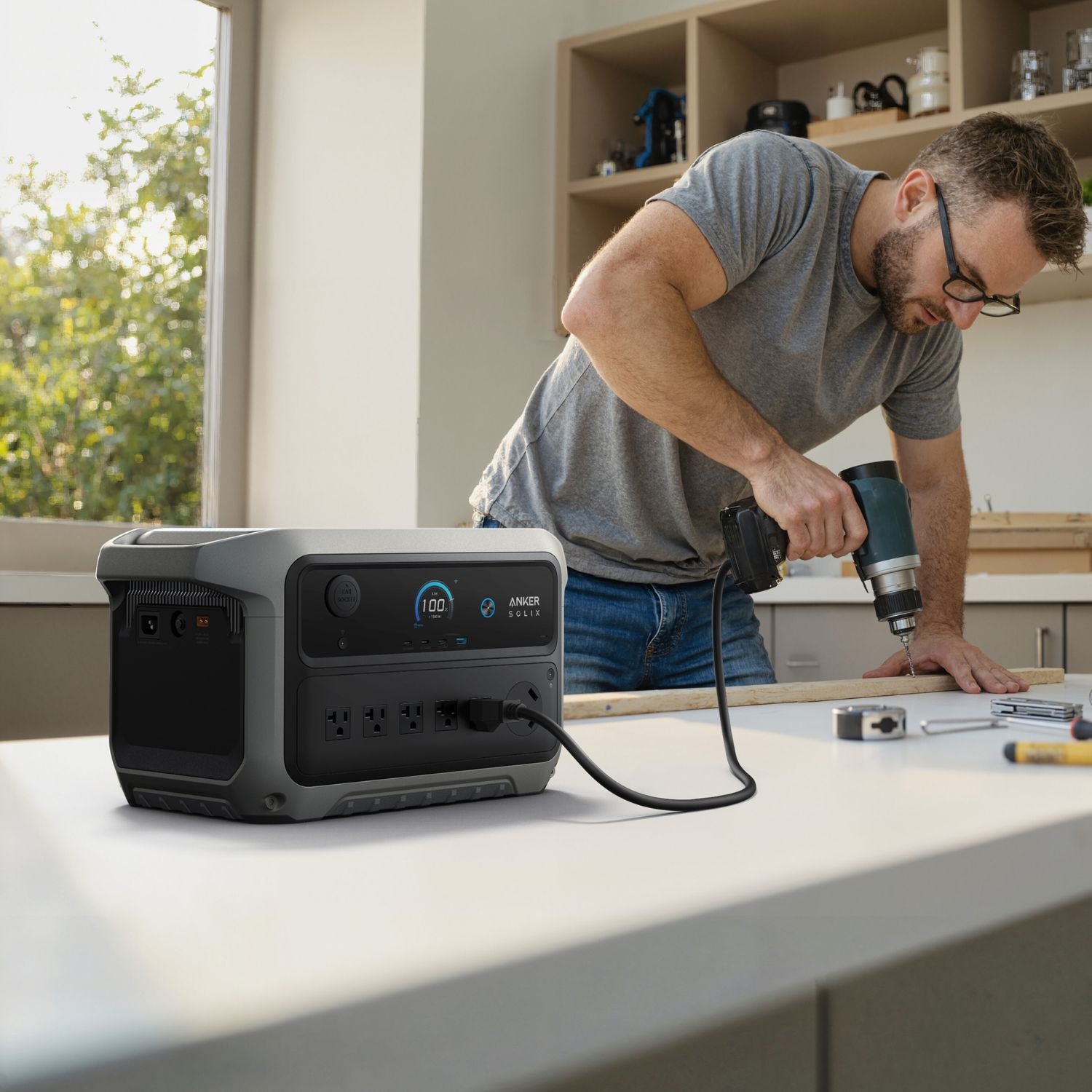 Person using a Anker SOLIX C2000 Gen 2 Portable Power Station with tools in a workshop setting