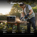 Person using a power tool with a Anker SOLIX C1000 Gen 2 Portable Power Station, outdoor setting
