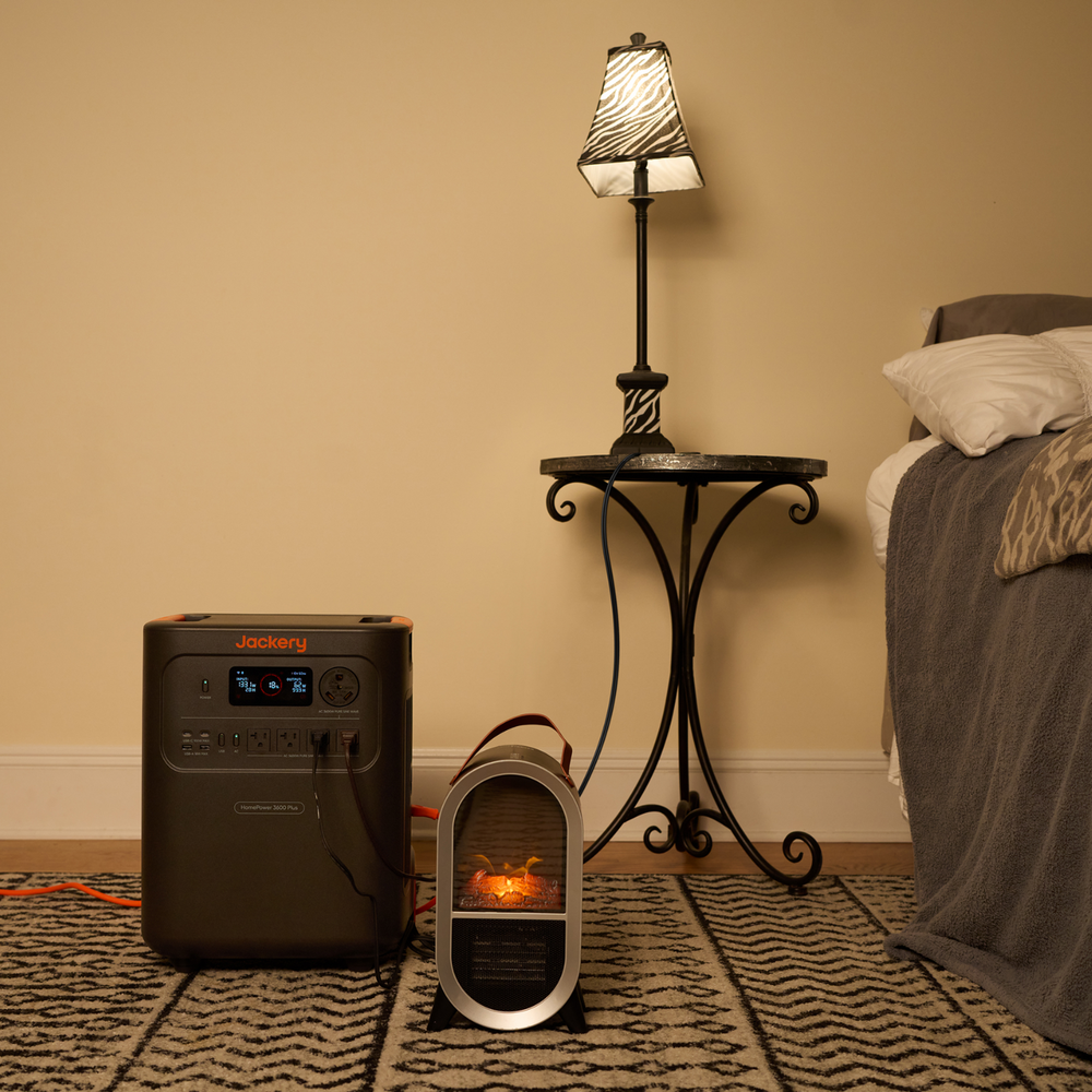 Portable heater on a rug next to a lamp and bed in a room connected to Jackery HomePower 3600 Plus Portable Power Station