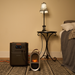 Portable heater on a rug next to a lamp and bed in a room connected to Jackery HomePower 3600 Plus Portable Power Station