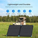 Renogy Solar Suitcase N-Type 100W Lightweight Portable Solar Panel on grass with vehicle and rooftop tent in background, featuring durability and efficiency text.