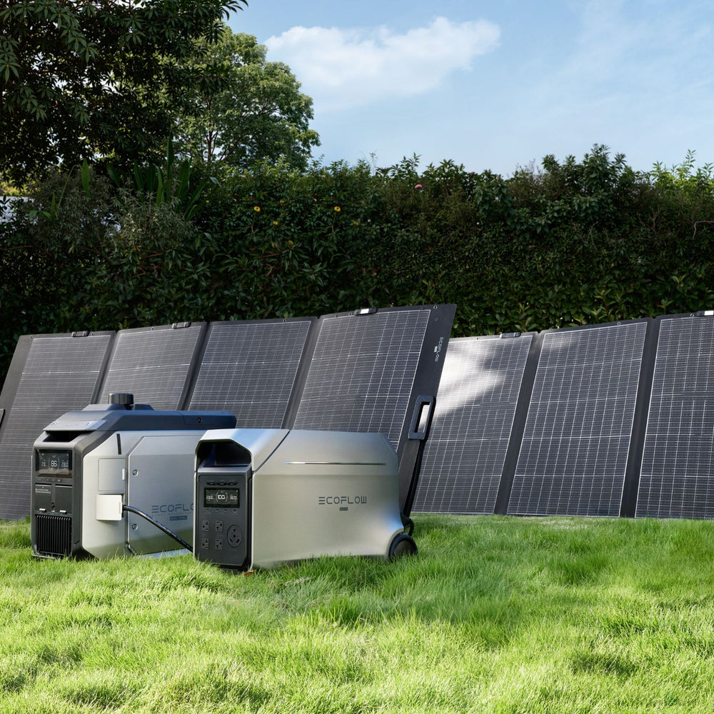 Solar panels and EcoFlow DELTA 3 Ultra Plus Portable Power Station on grass with trees and blue sky in the background