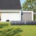 Solar panels on grass in front of a modern house connected to Anker SOLIX C2000 Gen 2 Portable Power Station