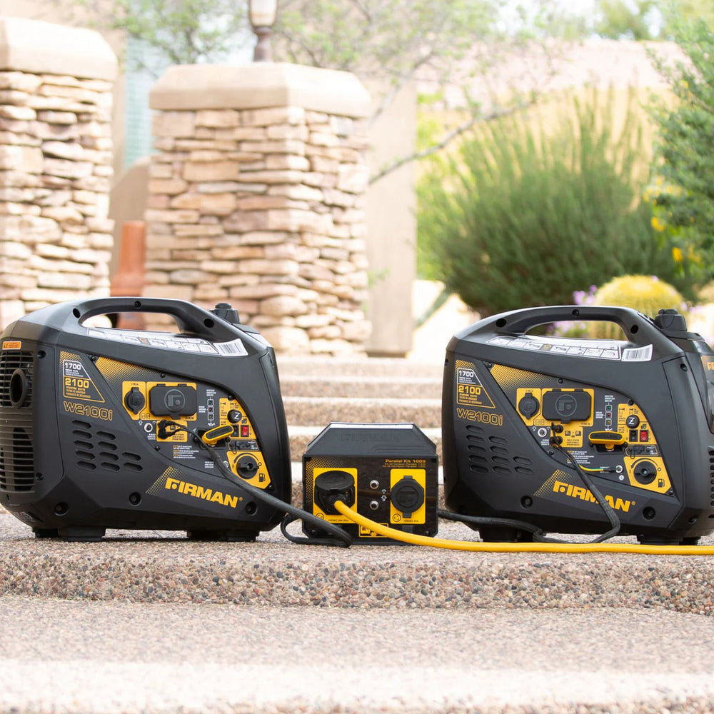 Two Firman W01781 Generator with a battery pack on a stone surface outdoors.