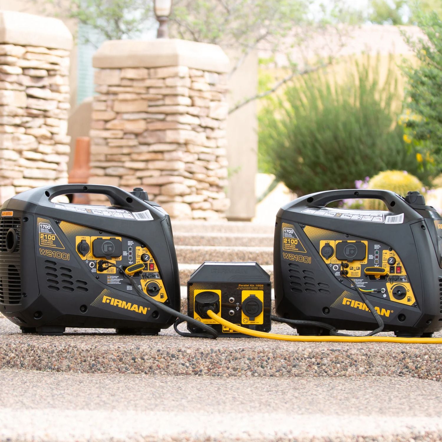 Two Firman W01781 Generator with a battery pack on a stone surface outdoors.